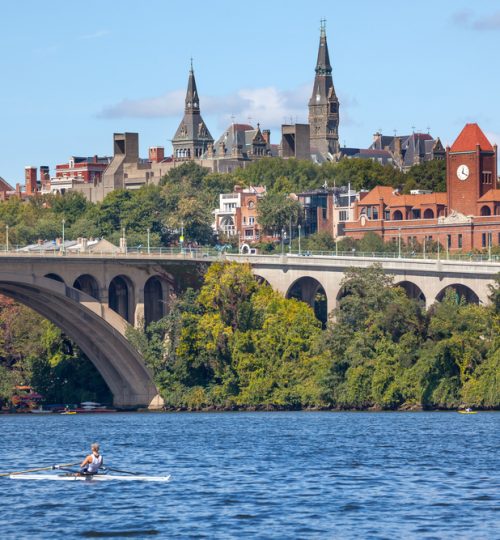 Rowing Potomac River Key Bridge Georgetown University Washington DC from Roosevelt Island.  Completed in 1923 this is the oldest bridge in Washington DC.